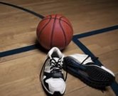 Basketball and sneakers on court